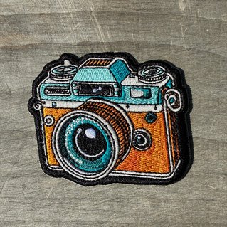 Geborduurde badge van een retro fototoestel
